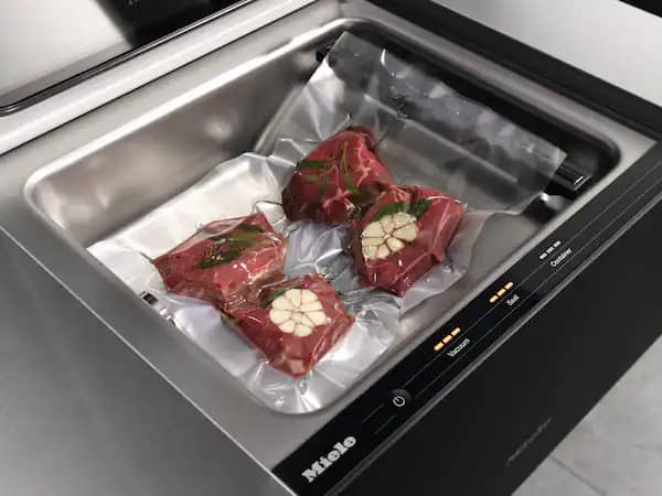 Miele-Vacuum-Sealing-Drawer-11845480-aerial-view-steaks-garlic.jpg